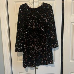 A long sleeve, velvet, sequin dress with an open back; never worn!